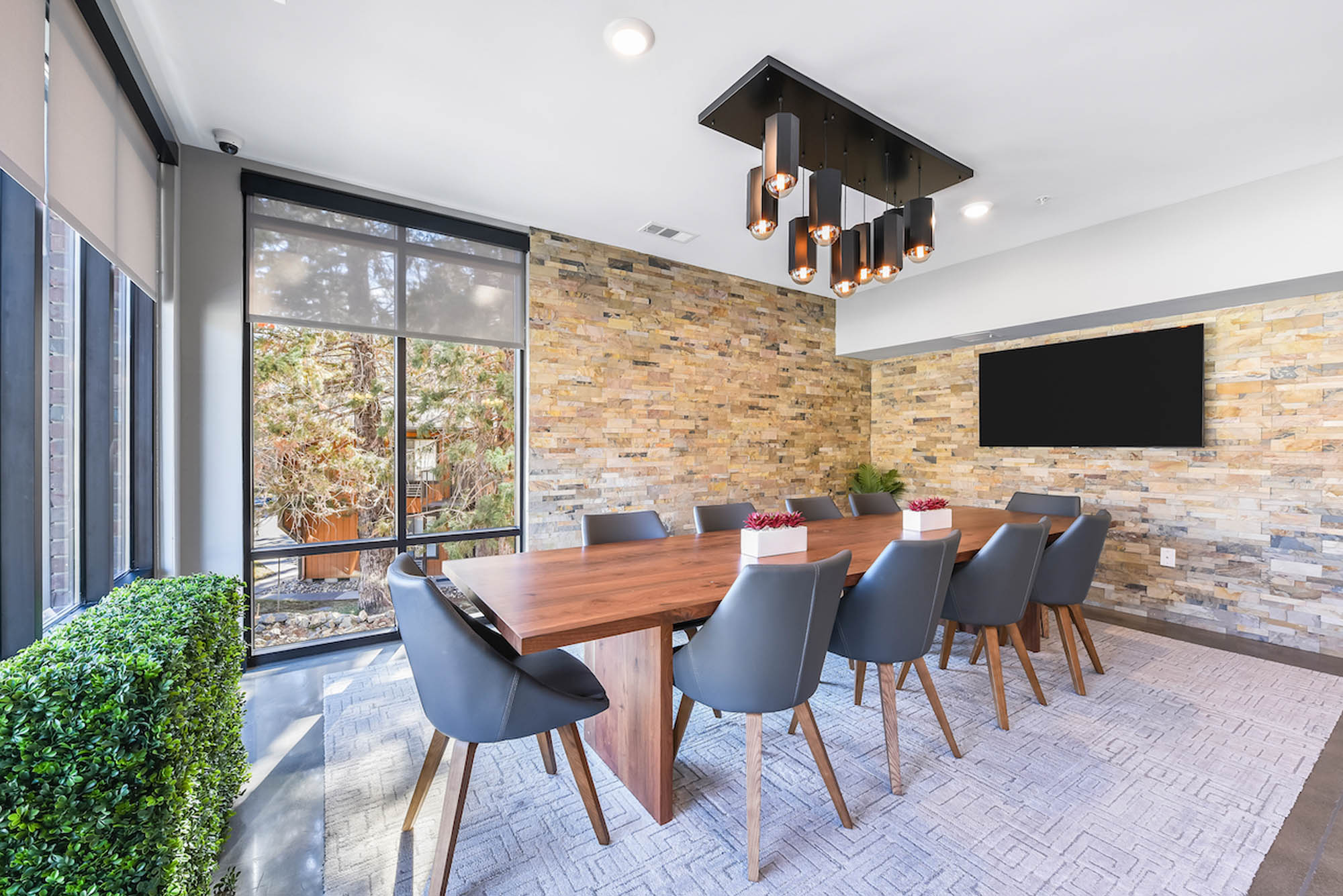 Modern dining table area with seating and decorative plants