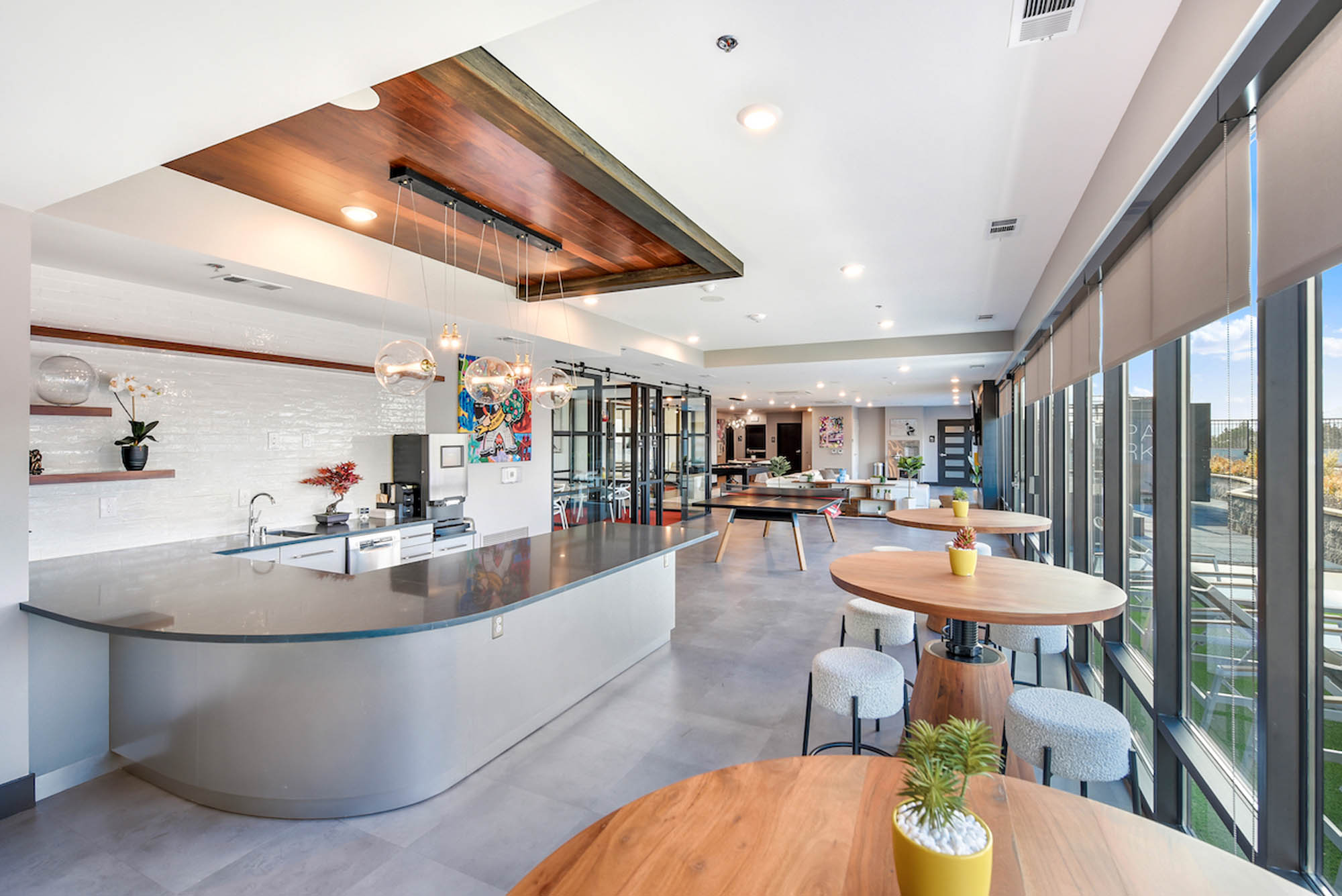 Modern kitchen and lounge space with large windows