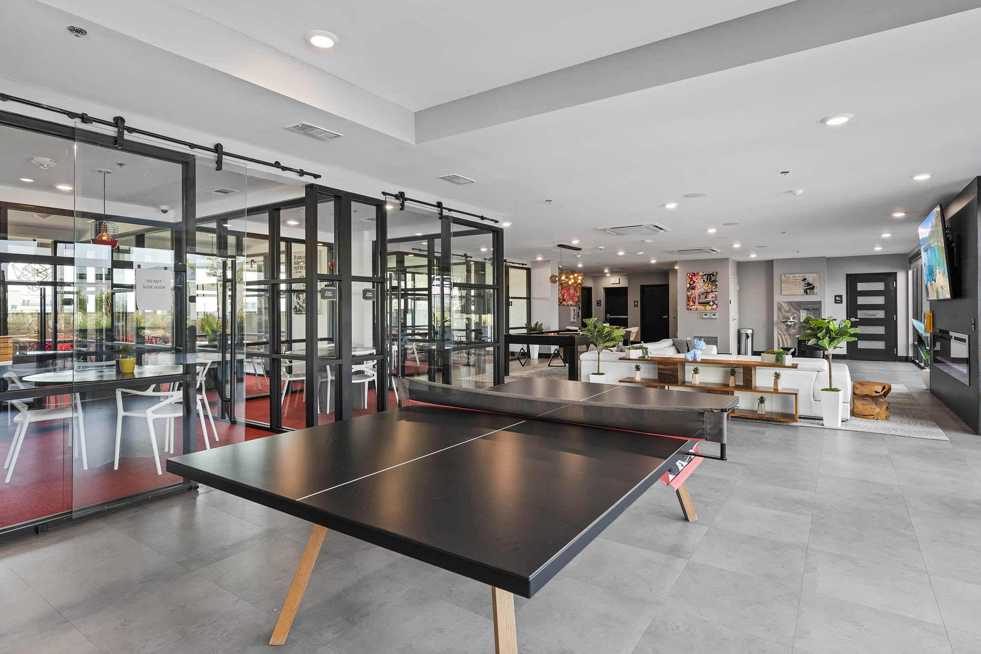 modern lounge area featuring a ping pong table gl